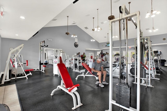 gym featuring a notable chandelier and high vaulted ceiling