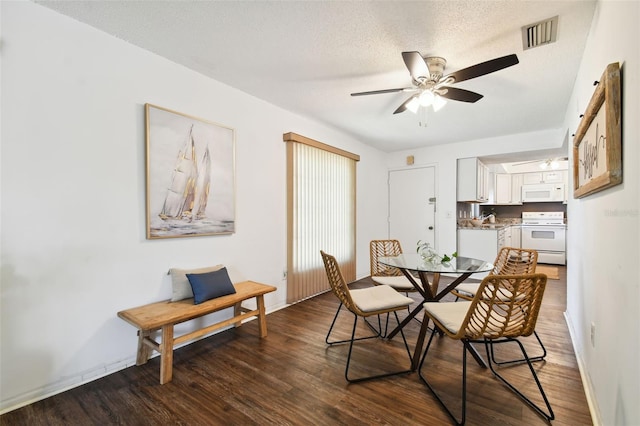 dining room with a textured ceiling, ceiling fan, and hardwood / wood-style flooring