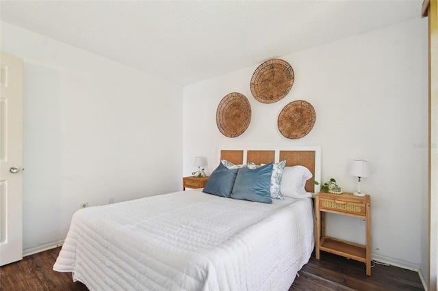 bedroom with dark hardwood / wood-style floors