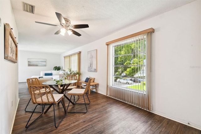 dining room with hardwood / wood-style flooring, a textured ceiling, and ceiling fan