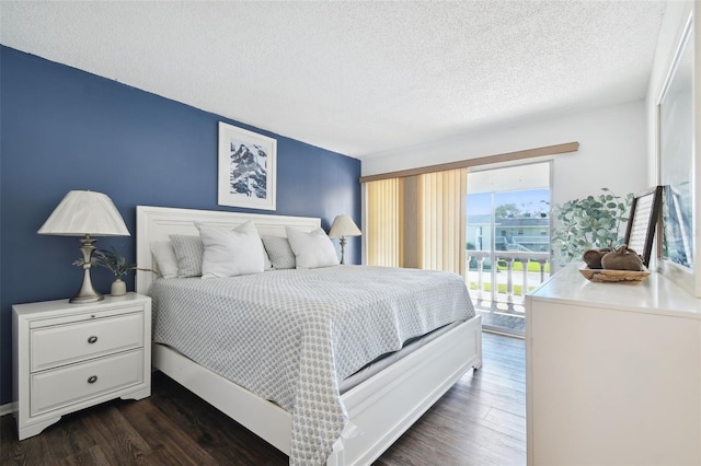 bedroom featuring dark hardwood / wood-style floors, a textured ceiling, and access to exterior