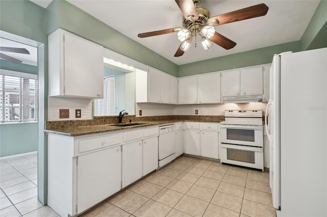 kitchen with light tile patterned floors, white appliances, sink, and white cabinetry