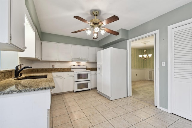 kitchen featuring white appliances, ceiling fan with notable chandelier, white cabinetry, light tile patterned floors, and sink