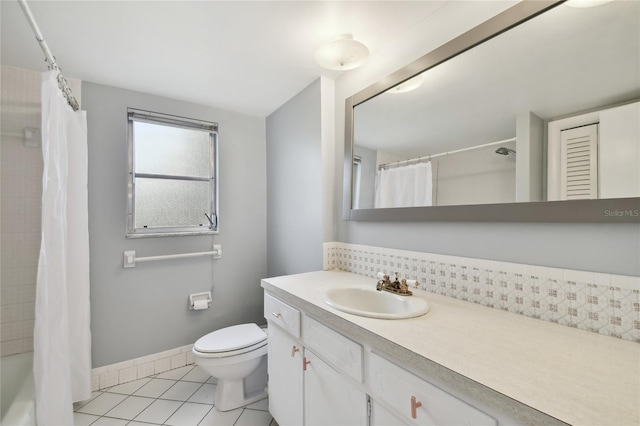 full bathroom with toilet, shower / tub combo with curtain, vanity, and tile patterned flooring