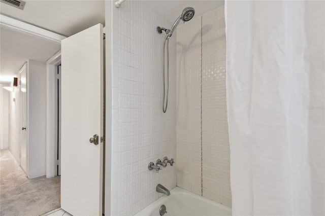 bathroom with shower / bath combination with curtain