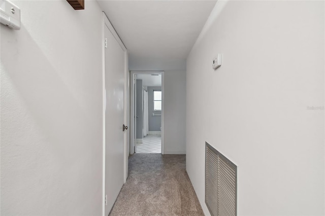 hall featuring light tile patterned flooring