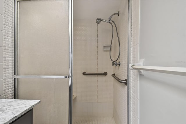 bathroom with an enclosed shower and vanity