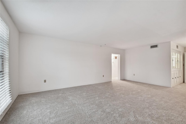 empty room featuring light colored carpet