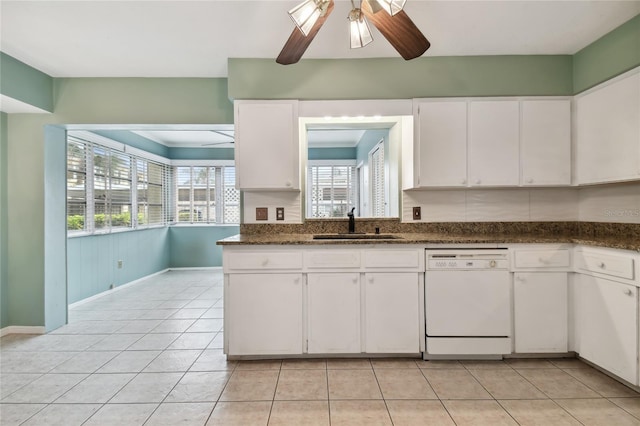 kitchen with light tile patterned floors, dishwasher, dark stone counters, ceiling fan, and white cabinets