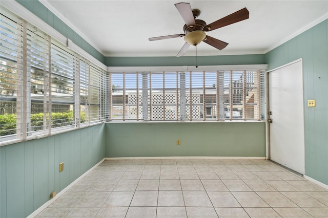 unfurnished sunroom featuring ceiling fan