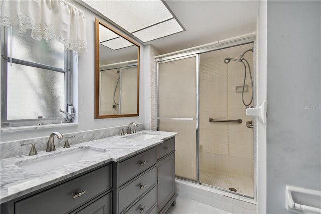 bathroom with walk in shower, dual bowl vanity, and tile patterned flooring