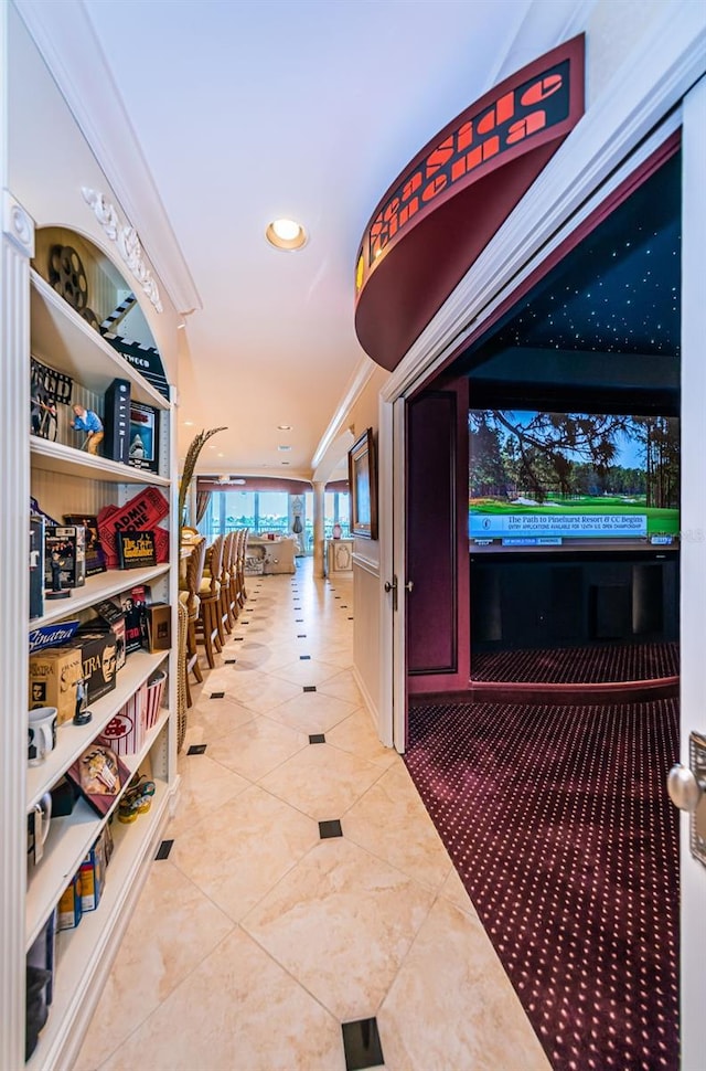 hall with crown molding and light tile floors