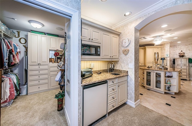 kitchen featuring sink, light stone countertops, ceiling fan, and black microwave