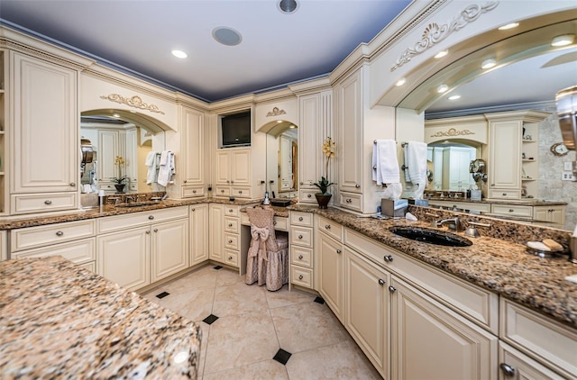 bathroom featuring double sink, tile flooring, oversized vanity, and ornamental molding