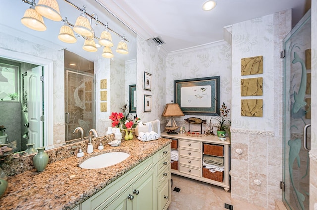 bathroom with ornamental molding, tile floors, a shower with shower door, and oversized vanity