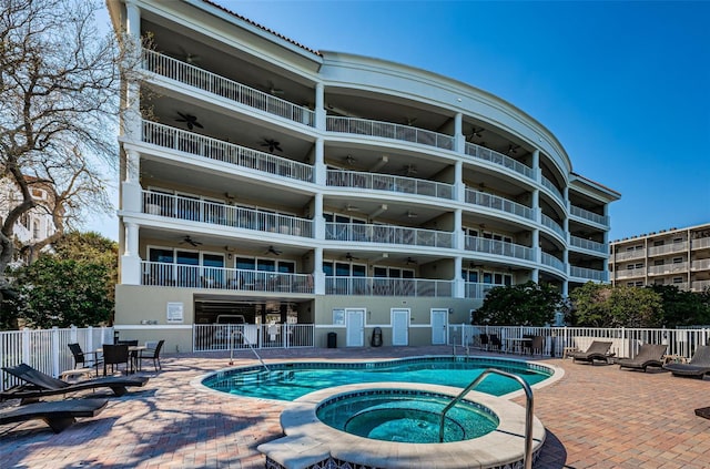 view of pool featuring a hot tub and a patio