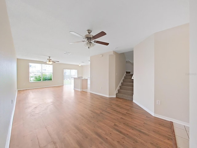 spare room with ceiling fan and light wood-type flooring