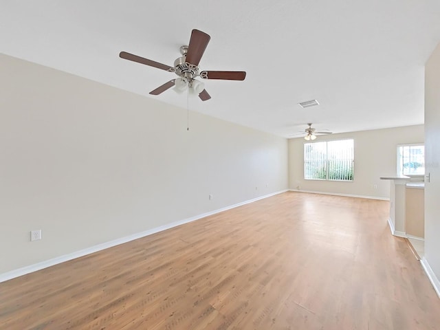 spare room with light hardwood / wood-style flooring and ceiling fan