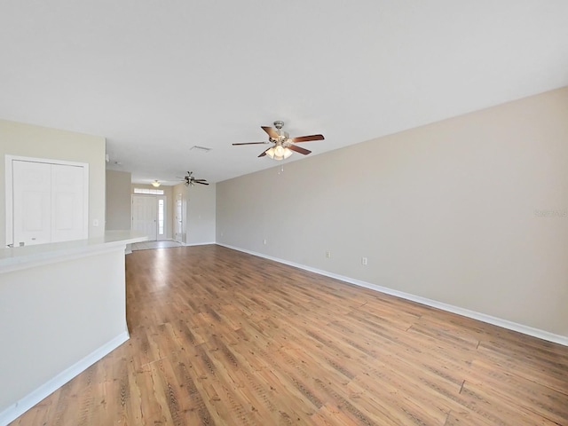 empty room with light hardwood / wood-style floors and ceiling fan