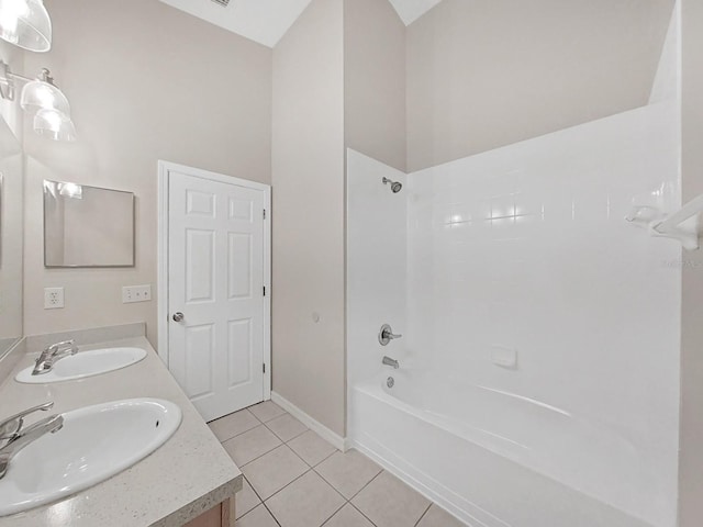 bathroom with shower / bath combination, dual sinks, vanity with extensive cabinet space, and tile flooring