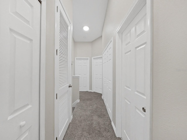 hallway with dark carpet