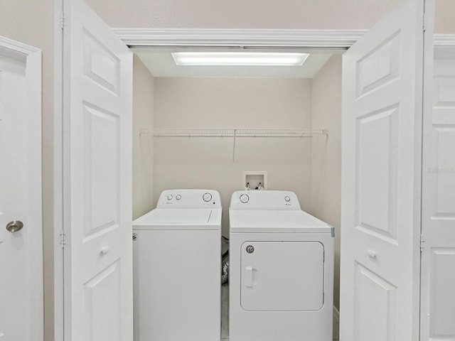 laundry room with washer hookup and washing machine and clothes dryer