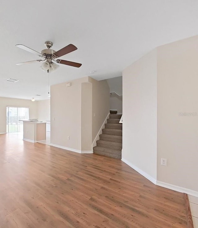 spare room with ceiling fan and light wood-type flooring