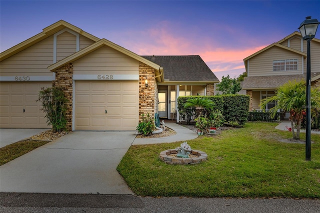 view of front of property with a yard and a garage