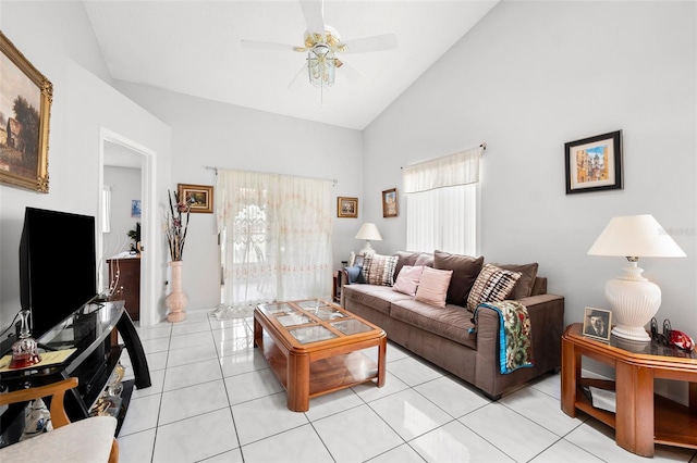 tiled living room with ceiling fan and high vaulted ceiling