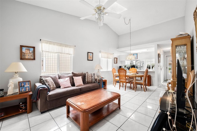 living room with high vaulted ceiling, ceiling fan, and light tile flooring