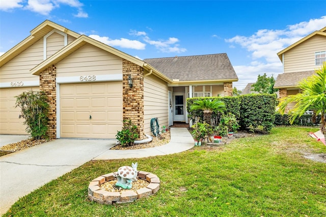 view of front of property with a front yard and a garage