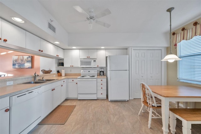 kitchen featuring white appliances, ceiling fan, sink, decorative light fixtures, and white cabinetry