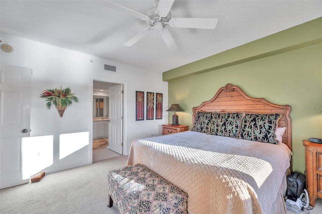 carpeted bedroom featuring connected bathroom and ceiling fan