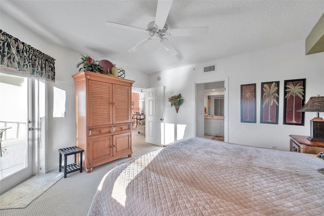 bedroom with connected bathroom, multiple windows, ceiling fan, and light colored carpet