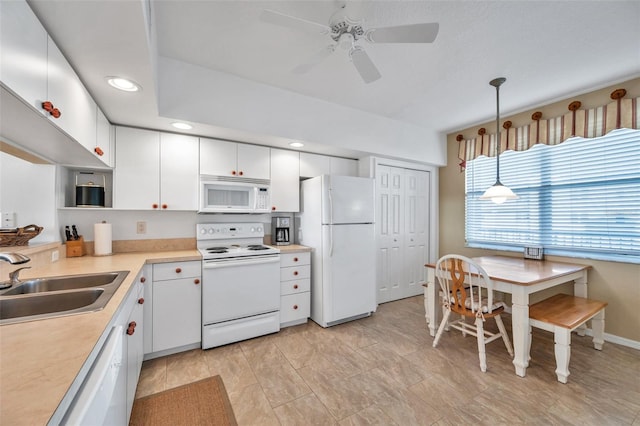 kitchen featuring pendant lighting, white appliances, sink, ceiling fan, and white cabinetry