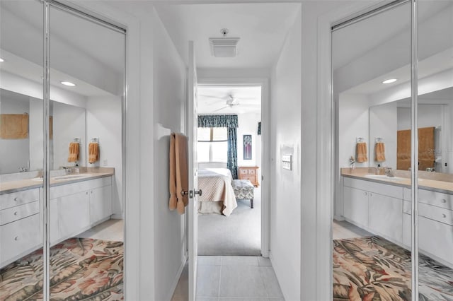 bathroom with tile patterned floors, vanity, and ceiling fan