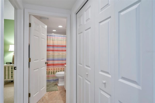 corridor with light tile patterned floors