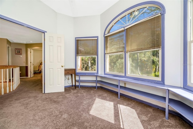 empty room featuring built in desk and carpet floors