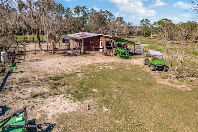 view of yard with an outbuilding and a rural view