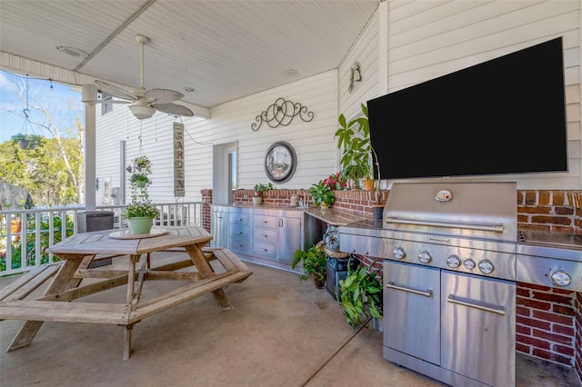 view of patio with a porch, ceiling fan, and exterior kitchen