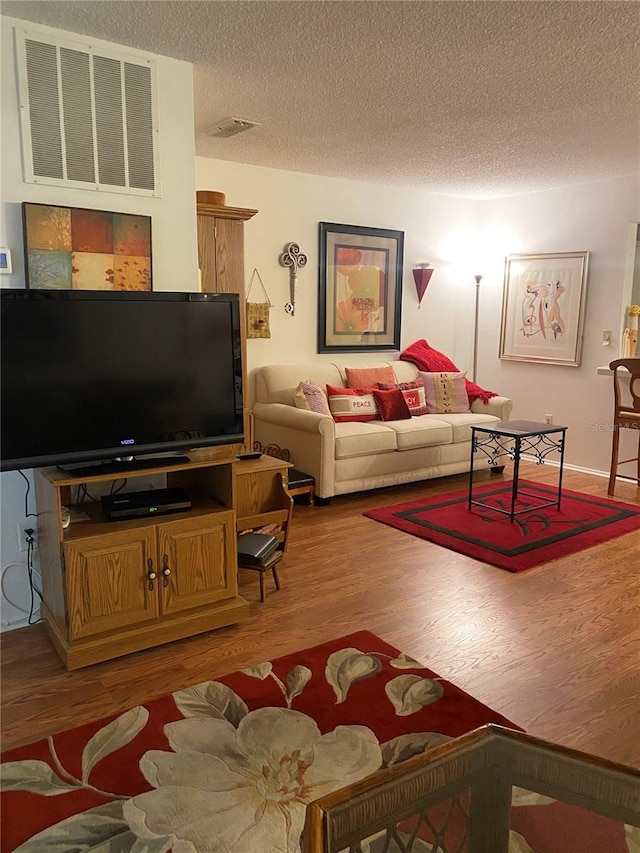 living room featuring a textured ceiling and hardwood / wood-style flooring