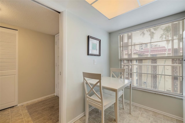 dining space featuring light tile floors