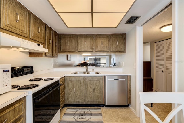 kitchen with white appliances, sink, and light tile flooring