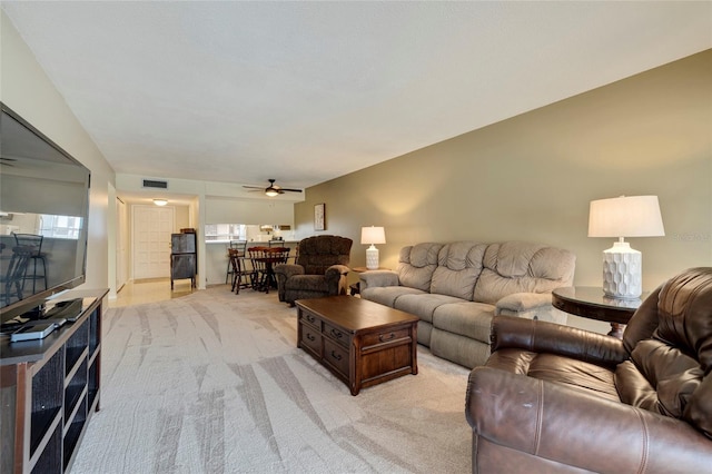 carpeted living room featuring ceiling fan