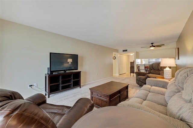 living room with light carpet and ceiling fan