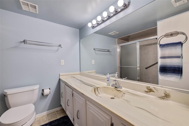 bathroom with tile flooring, vanity with extensive cabinet space, and toilet