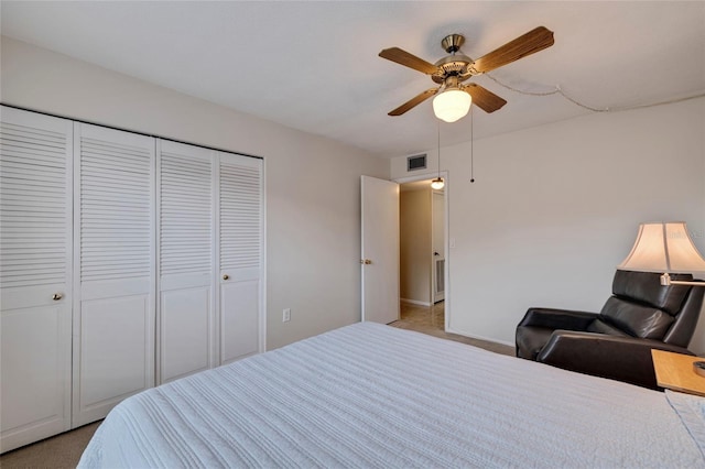 bedroom featuring light colored carpet, a closet, and ceiling fan