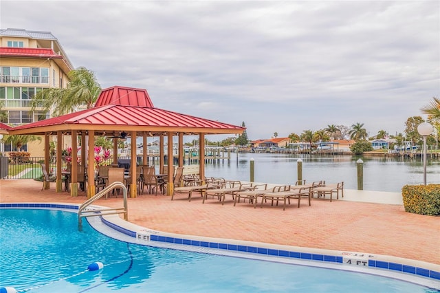 view of pool with a gazebo and a water view