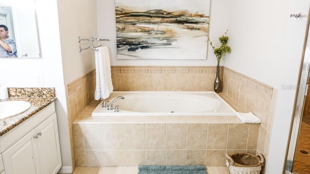 bathroom with tiled bath and vanity