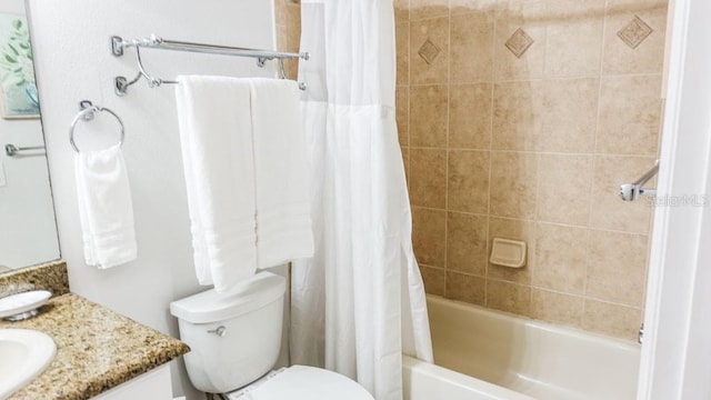 full bathroom featuring shower / tub combo, vanity with extensive cabinet space, and toilet